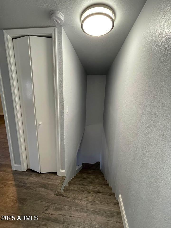 1455 North Alma School Road, Unit 11 Mesa, AZ 85201 - Photo 11 of 22 an empty room with wooden floor and windows