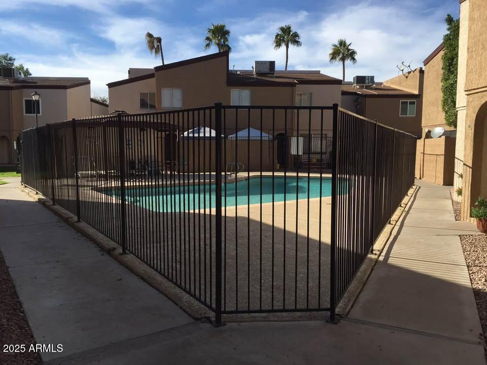 1455 North Alma School Road, Unit 11 Mesa, AZ 85201 - Photo 21 of 22 a view of a balcony with wooden fence