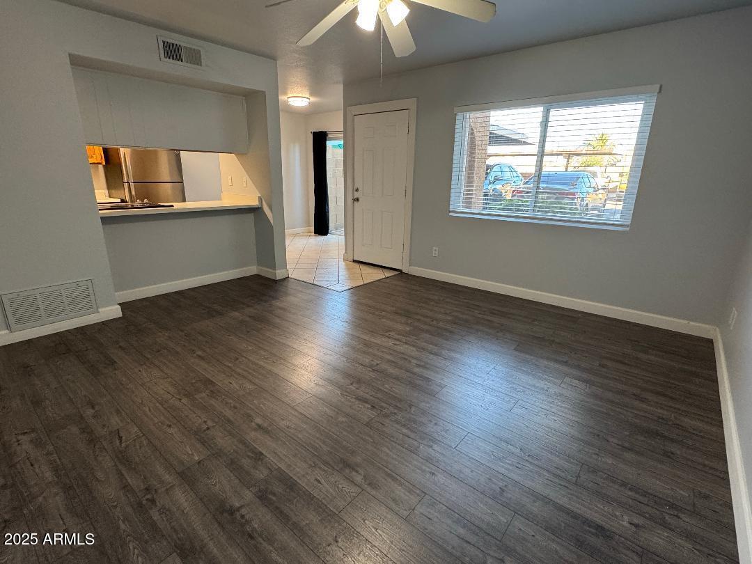 1455 North Alma School Road, Unit 11 Mesa, AZ 85201 - Photo 6 of 22 wooden floor in an empty room with a window