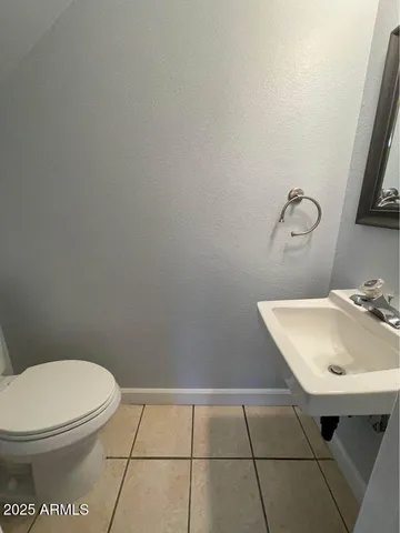 a bathroom with a sink a toilet and mirror