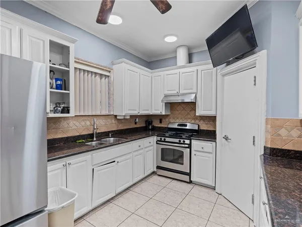 a living room with furniture gym equipment and a ceiling fan
