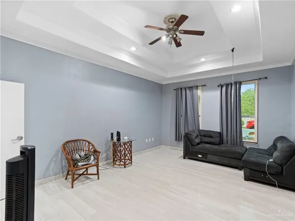 a view of an empty room with window and cabinet