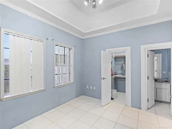 a spacious bathroom with a tub sink double vanity and mirror