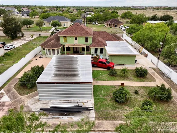 an aerial view of a house with a swimming pool
