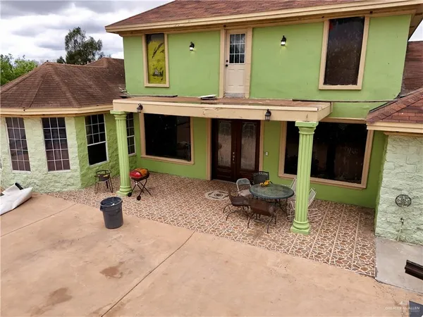 a view of a house with a yard and sitting area
