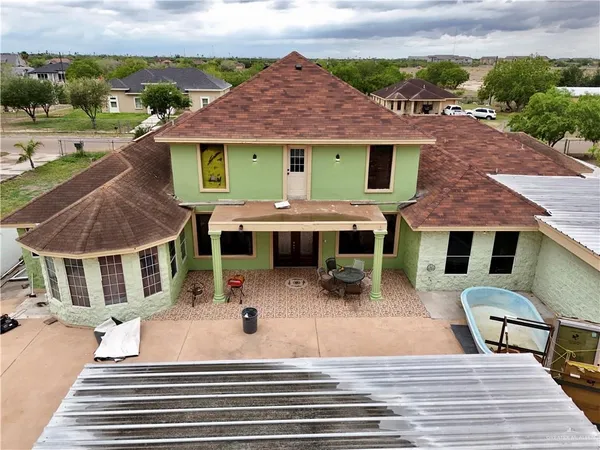 an aerial view of a house with garden space and street view