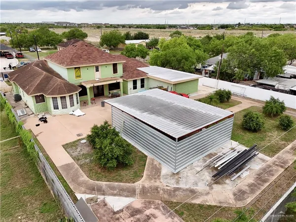 an aerial view of a house with a yard