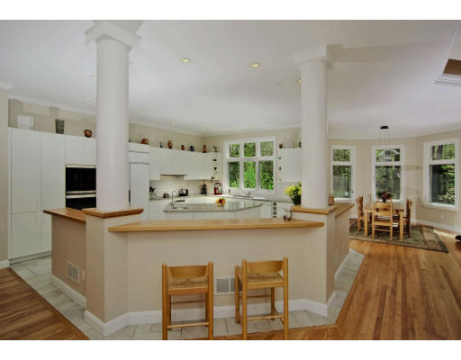 215 Monument Farm Road Concord, MA 01742 - Photo 5 of 8 a kitchen with kitchen island a sink table and chairs