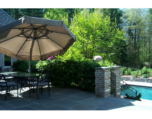 215 Monument Farm Road Concord, MA 01742 - Photo 8 of 8 a view of a backyard with furniture and a garden