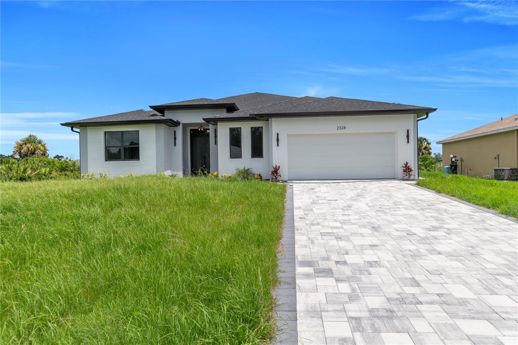 2328 Irondale Road North Port, FL 34287 - Photo 4 of 45 a front view of a house with a yard and garage