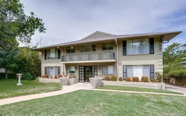 a front view of a house with a yard table and chairs