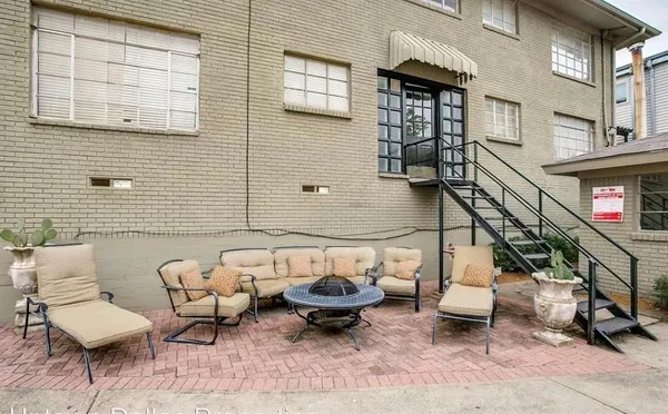 a view of a patio with couple of chairs and a couch