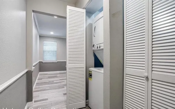 a view of a bathroom from the walk in closet