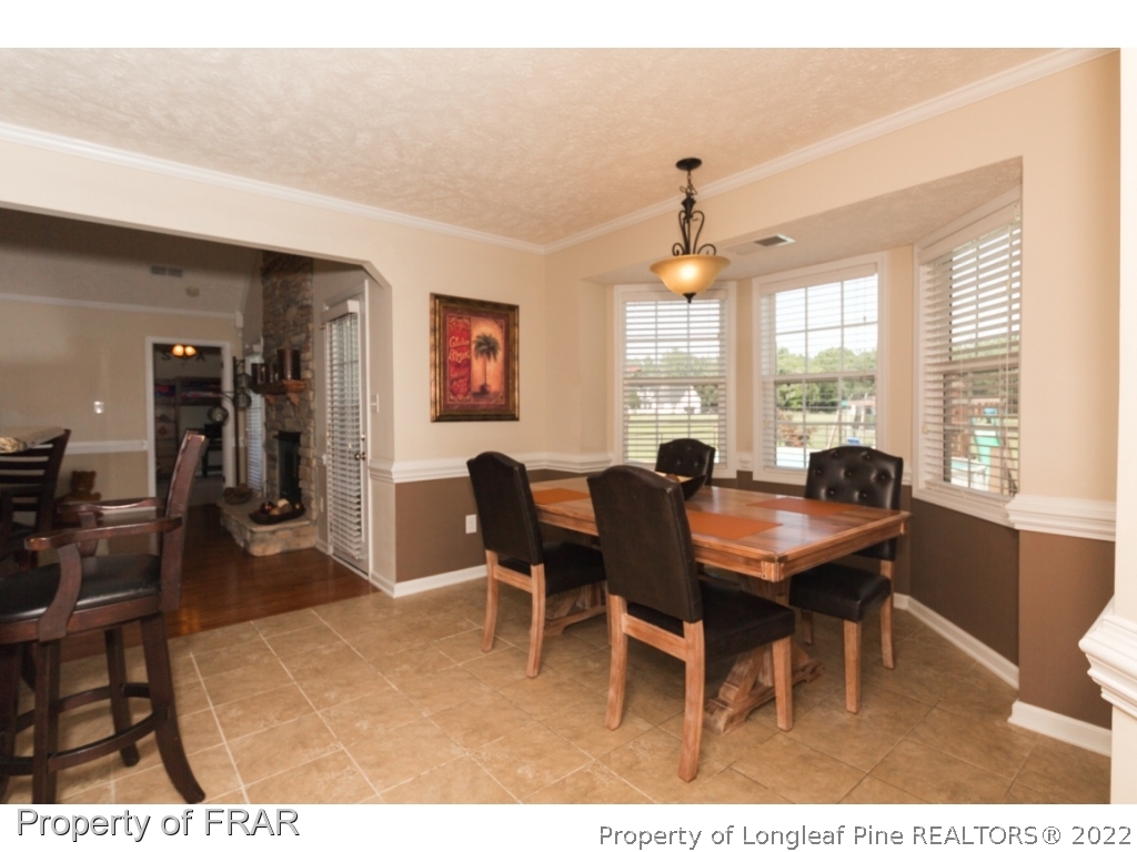 2854 Wade-Stedman Road Stedman, NC 28391 - Photo 11 of 35 a view of a dining room with furniture and a large window