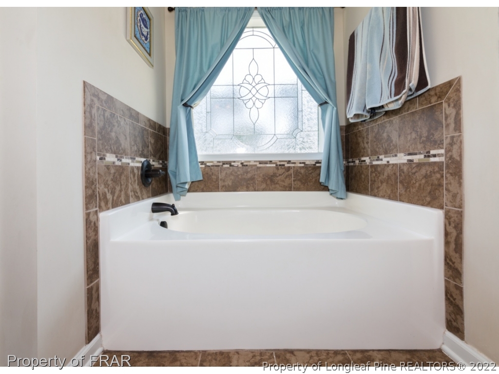 2854 Wade-Stedman Road Stedman, NC 28391 - Photo 17 of 35 a white bath tub sitting next to a window