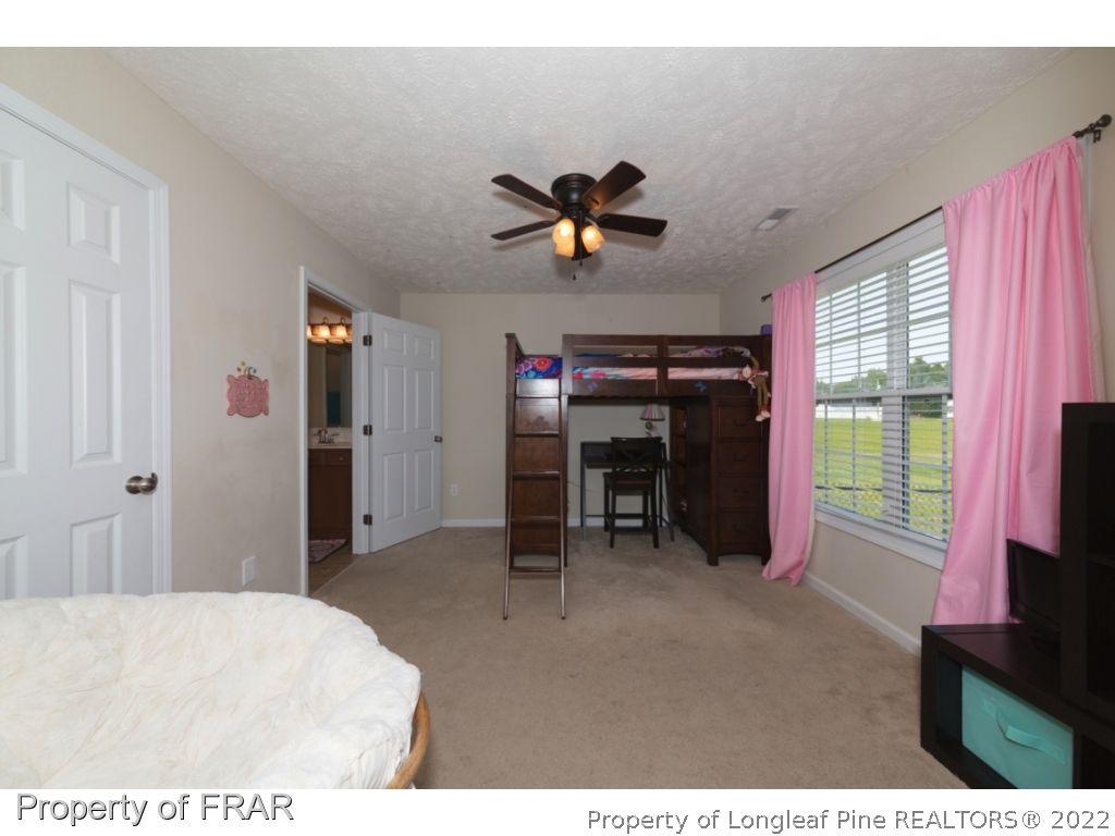 2854 Wade-Stedman Road Stedman, NC 28391 - Photo 21 of 35 a room with furniture and a flat screen tv