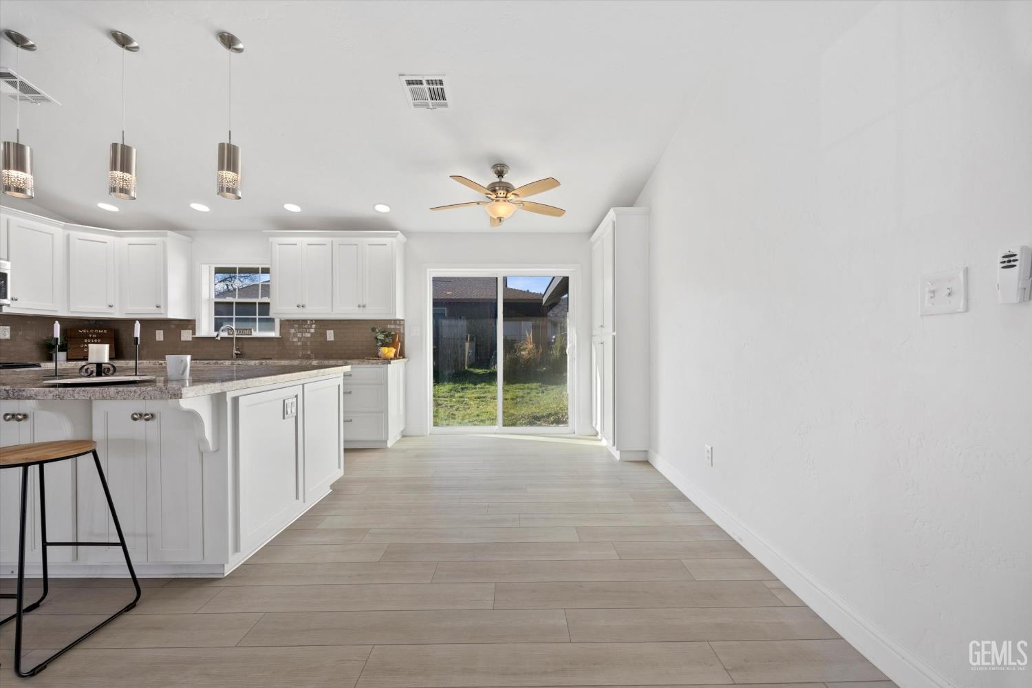 Undisclosed Address Tehachapi, CA 93561 - Photo 18 of 49 a large white kitchen with stainless steel appliances granite countertop a sink and cabinets