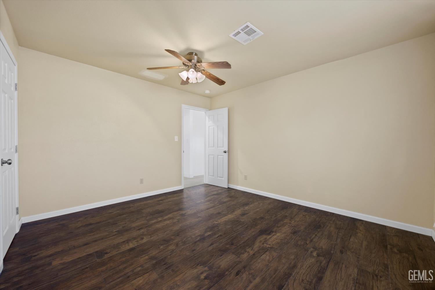 Undisclosed Address Tehachapi, CA 93561 - Photo 42 of 49 a view of an empty room with wooden floor and a ceiling fan