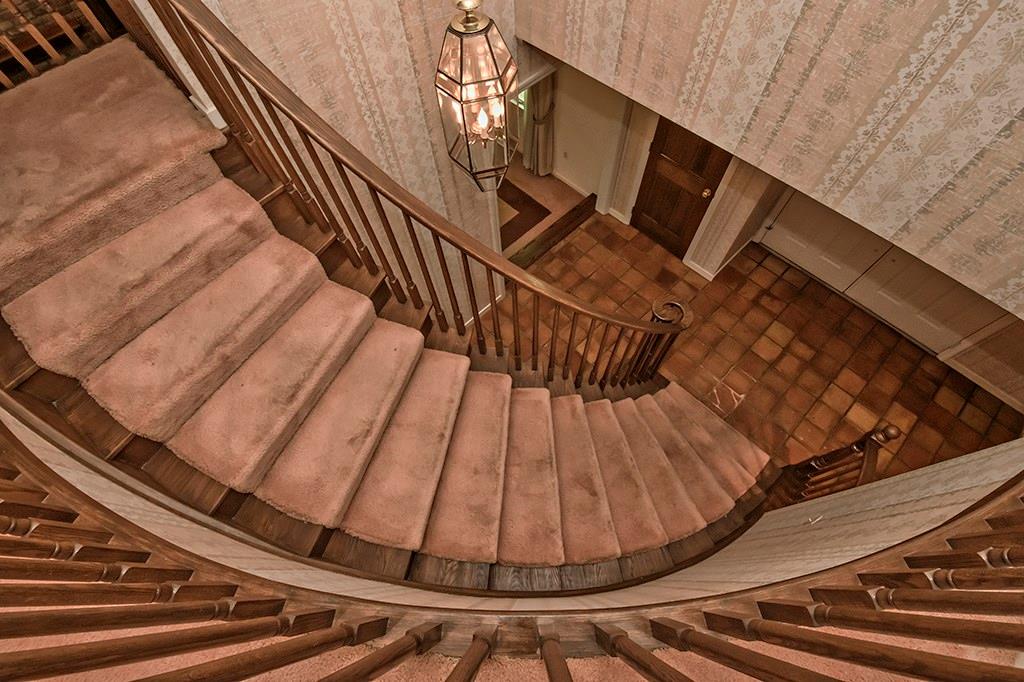 Beautifully designed staircase makes for an impressive entrance into the home. 
