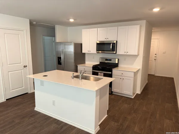 a kitchen with stainless steel appliances a refrigerator stove microwave and sink