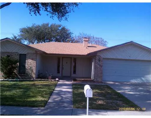 a front view of house with yard and trees