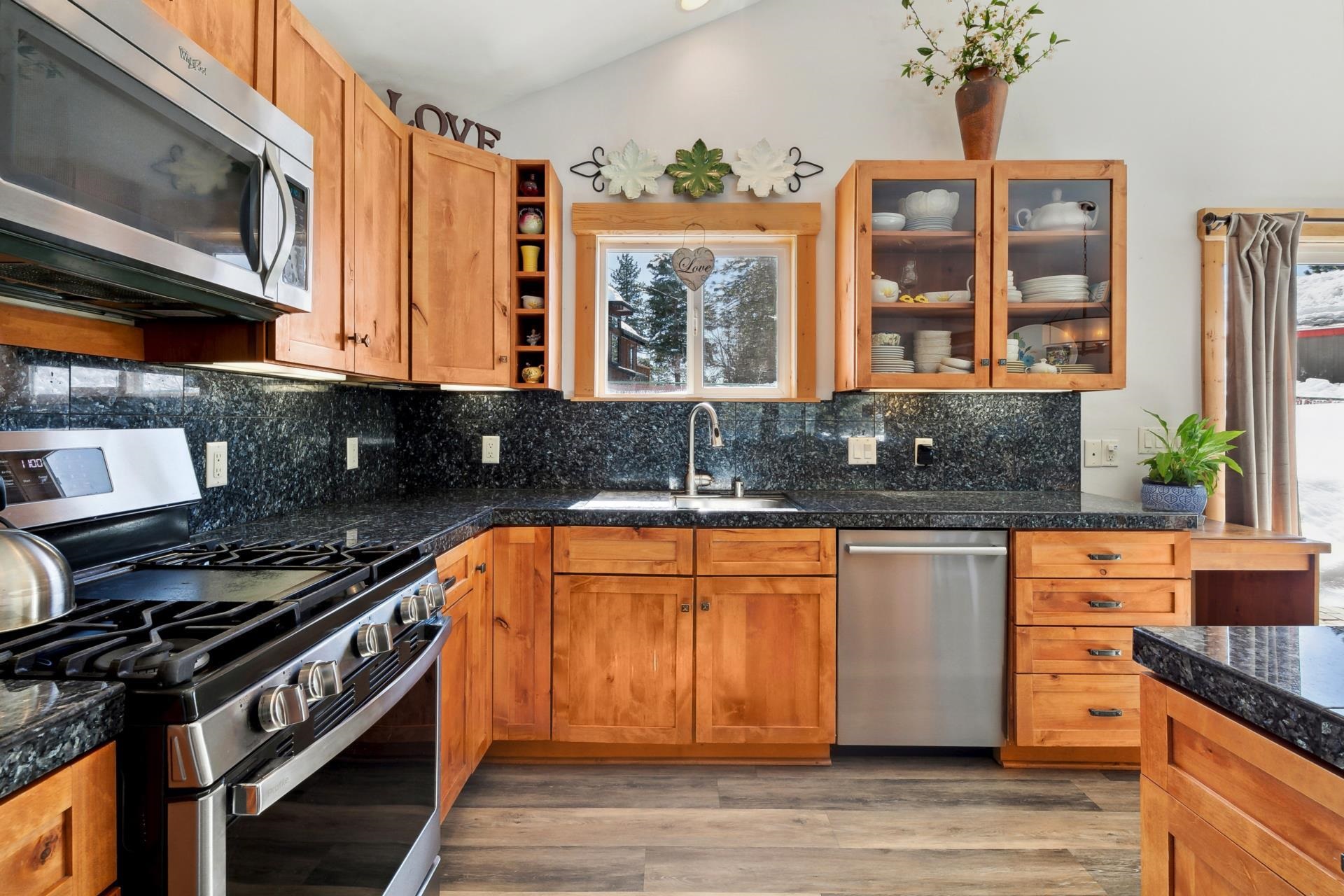 10383 Sugar Pine Road Truckee, CA 96161 - Photo 14 of 21 a kitchen with stainless steel appliances granite countertop a stove a sink and a microwave