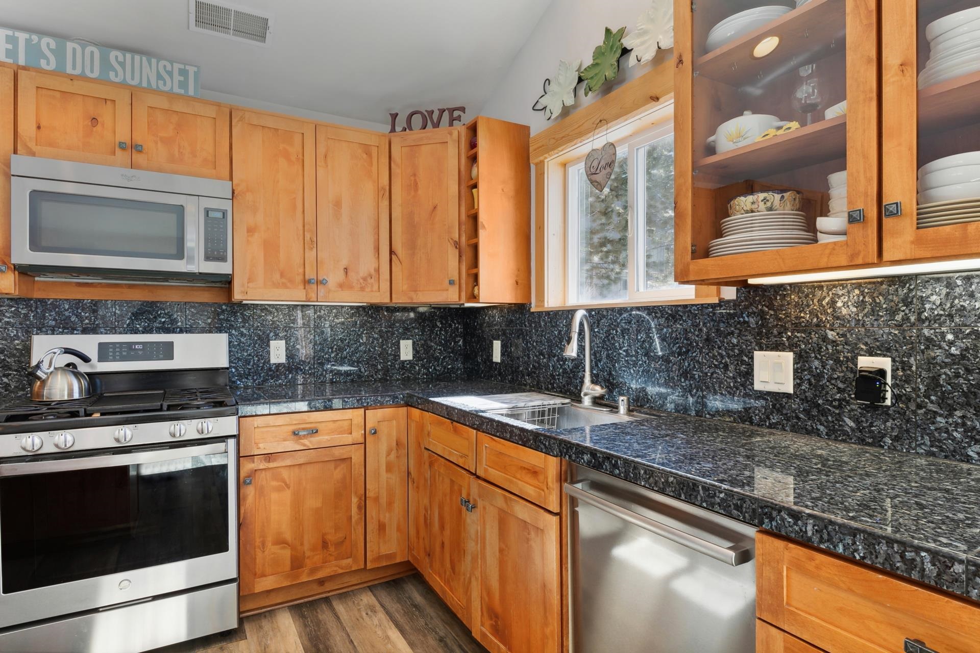 10383 Sugar Pine Road Truckee, CA 96161 - Photo 15 of 21 a kitchen with stainless steel appliances granite countertop a stove a sink and a microwave