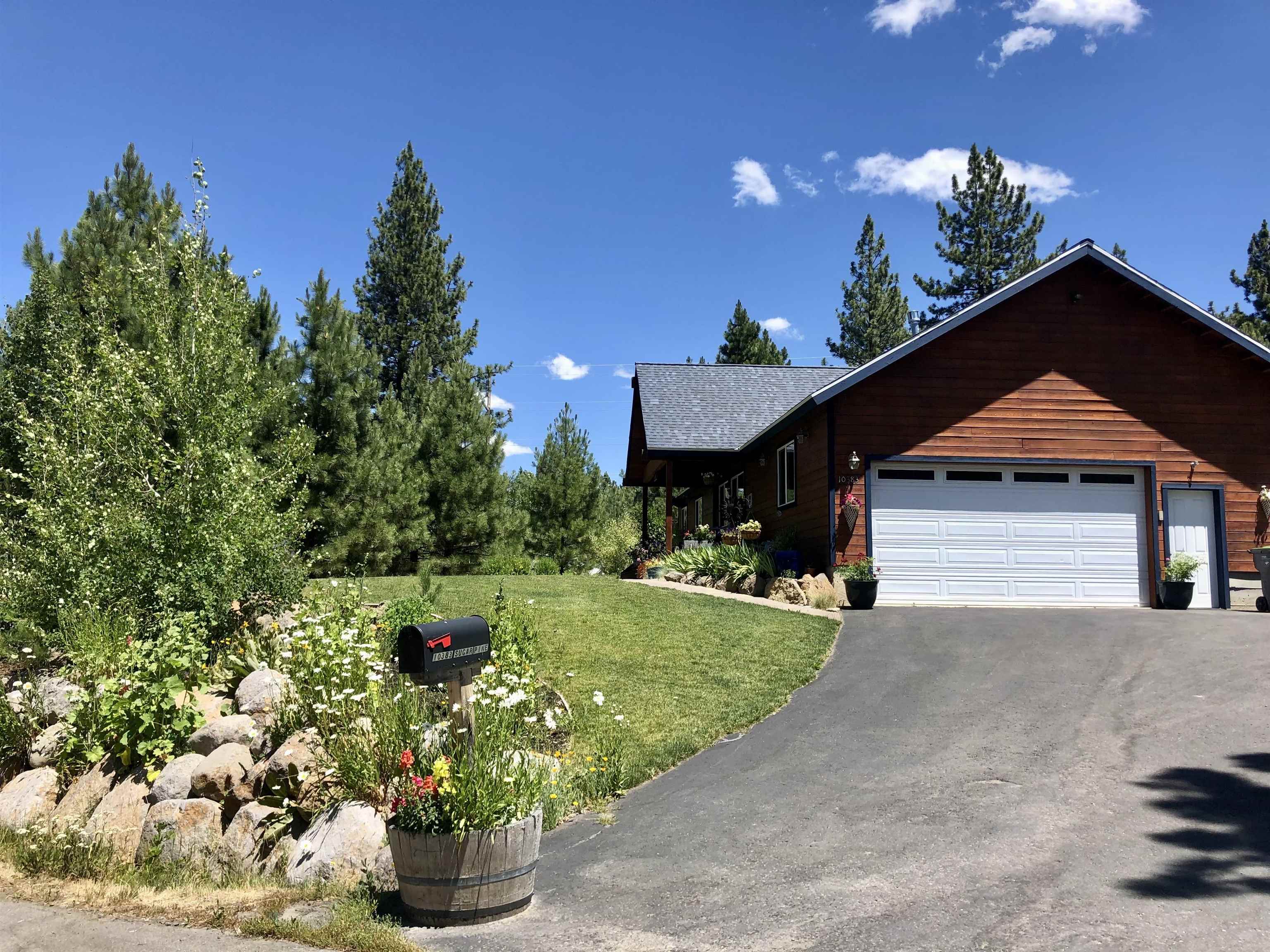 10383 Sugar Pine Road Truckee, CA 96161 - Photo 6 of 21 a front view of a house with a yard and garage