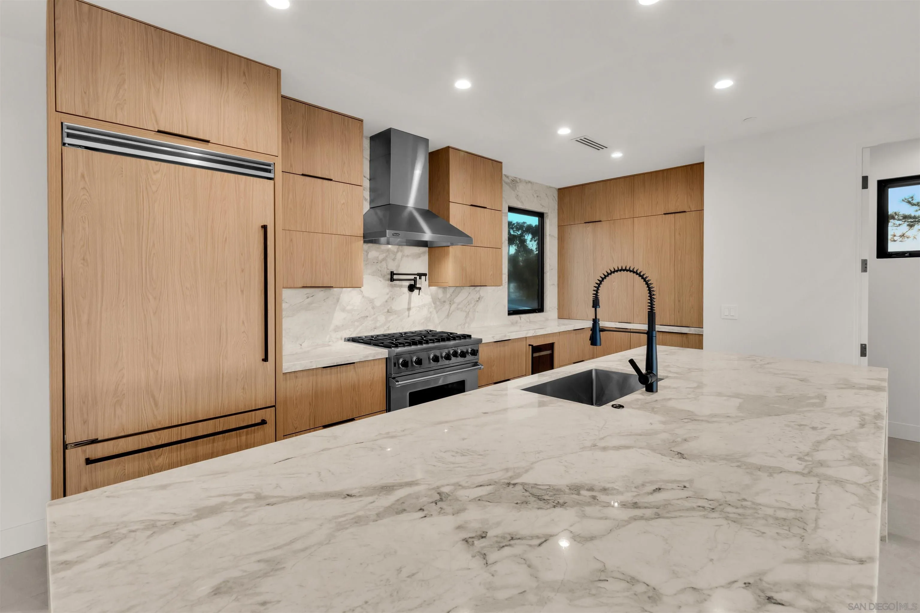 1009 Arcadia Road Encinitas, CA 92024 - Photo 11 of 37 a kitchen with stainless steel appliances granite countertop a refrigerator and a sink