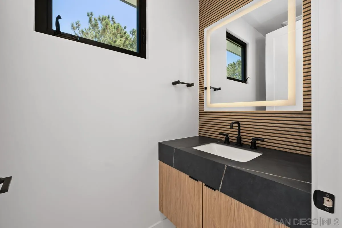 1009 Arcadia Road Encinitas, CA 92024 - Photo 14 of 37 a bathroom with a sink and a mirror