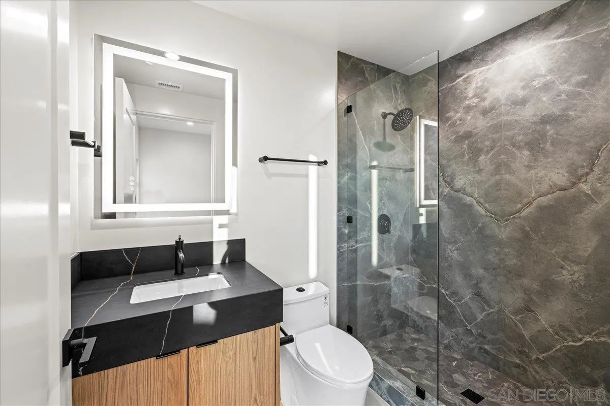 1009 Arcadia Road Encinitas, CA 92024 - Photo 31 of 37 a bathroom with a sink a toilet and shower