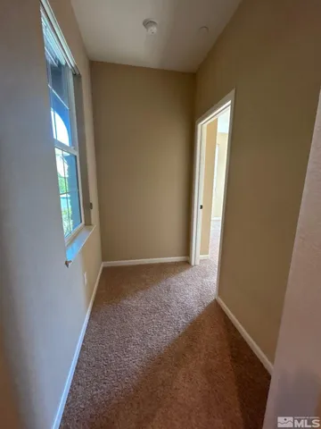 a view of hallway with windows
