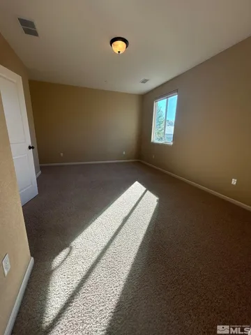 a view of an empty room and window