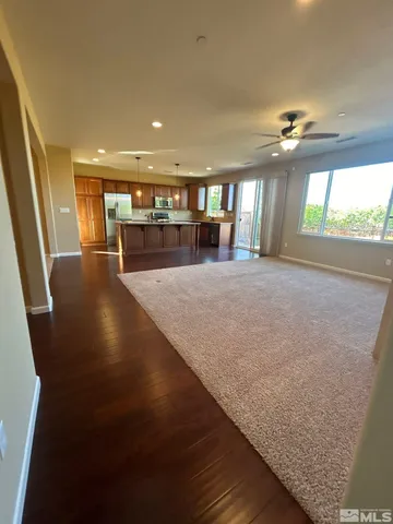 a view of a hallway with floor to ceiling window and wooden floor