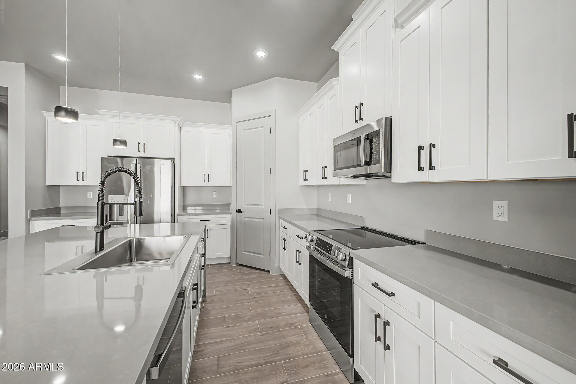 40461 West Robles Road Stanfield, AZ 85172 - Photo 29 of 54 a kitchen with stainless steel appliances granite countertop a sink stove refrigerator and cabinets