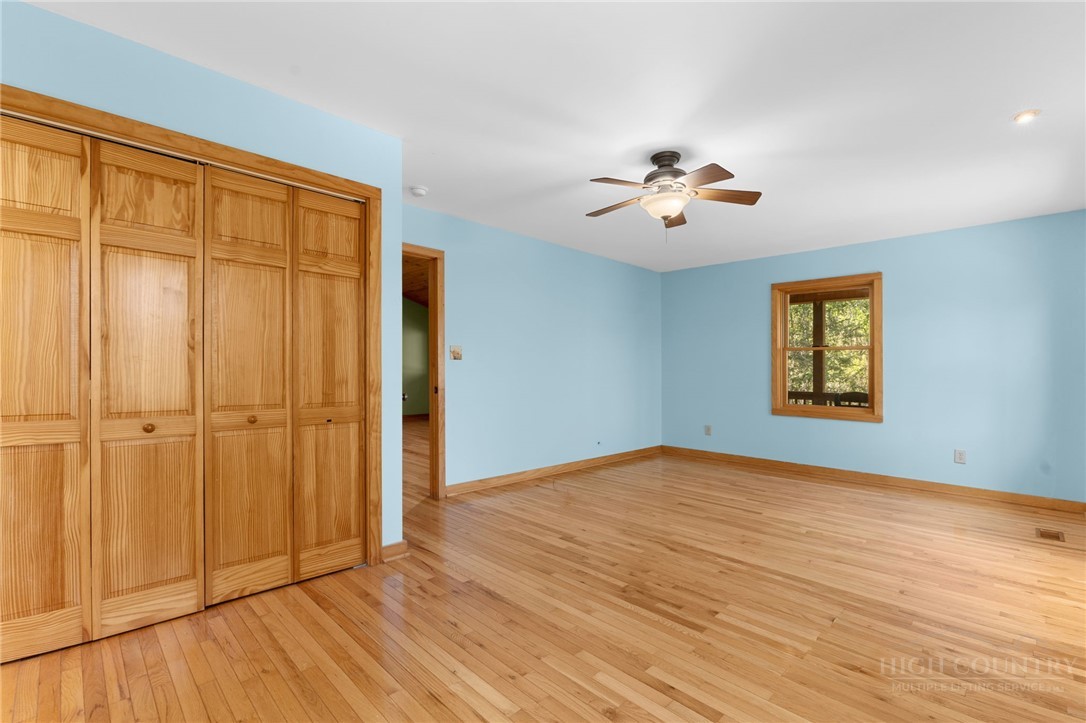 148 Woodby Ridge Road Vilas, NC 28692 - Photo 15 of 33 a view of an empty room with a window and a ceiling fan