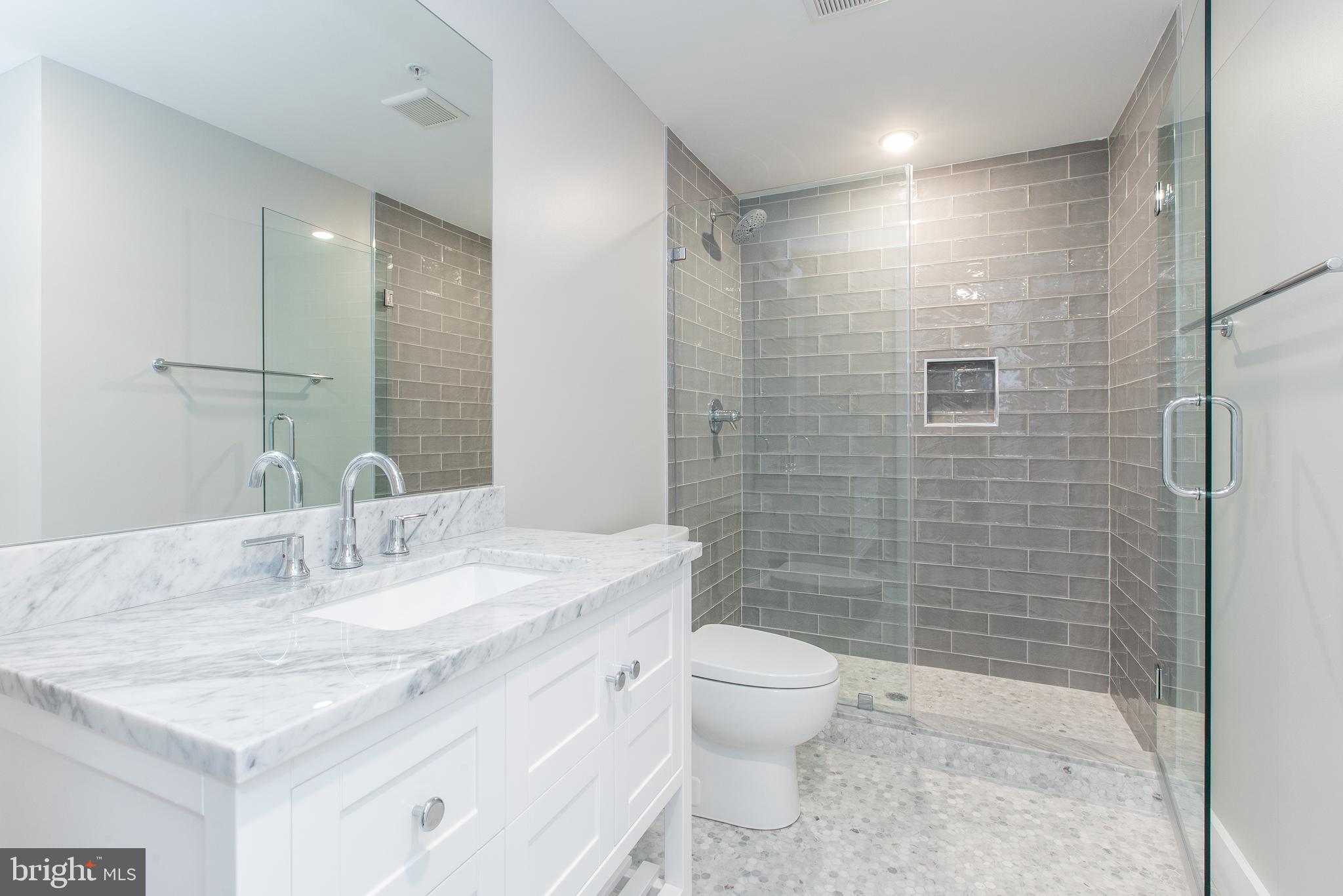 45 West Haines Street, Unit 303 Philadelphia, PA 19144 - Photo 12 of 24 a bathroom with a sink toilet and shower