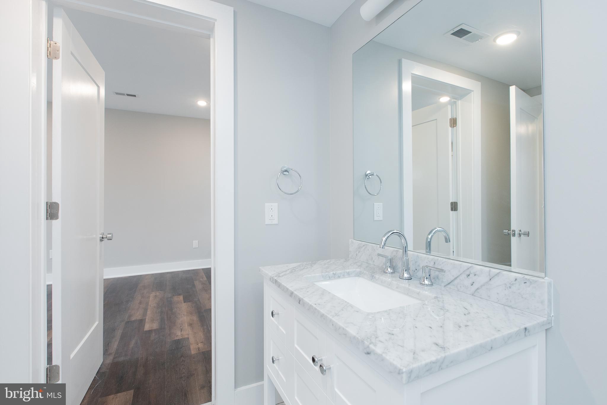 45 West Haines Street, Unit 303 Philadelphia, PA 19144 - Photo 15 of 24 a bathroom with a sink and a mirror
