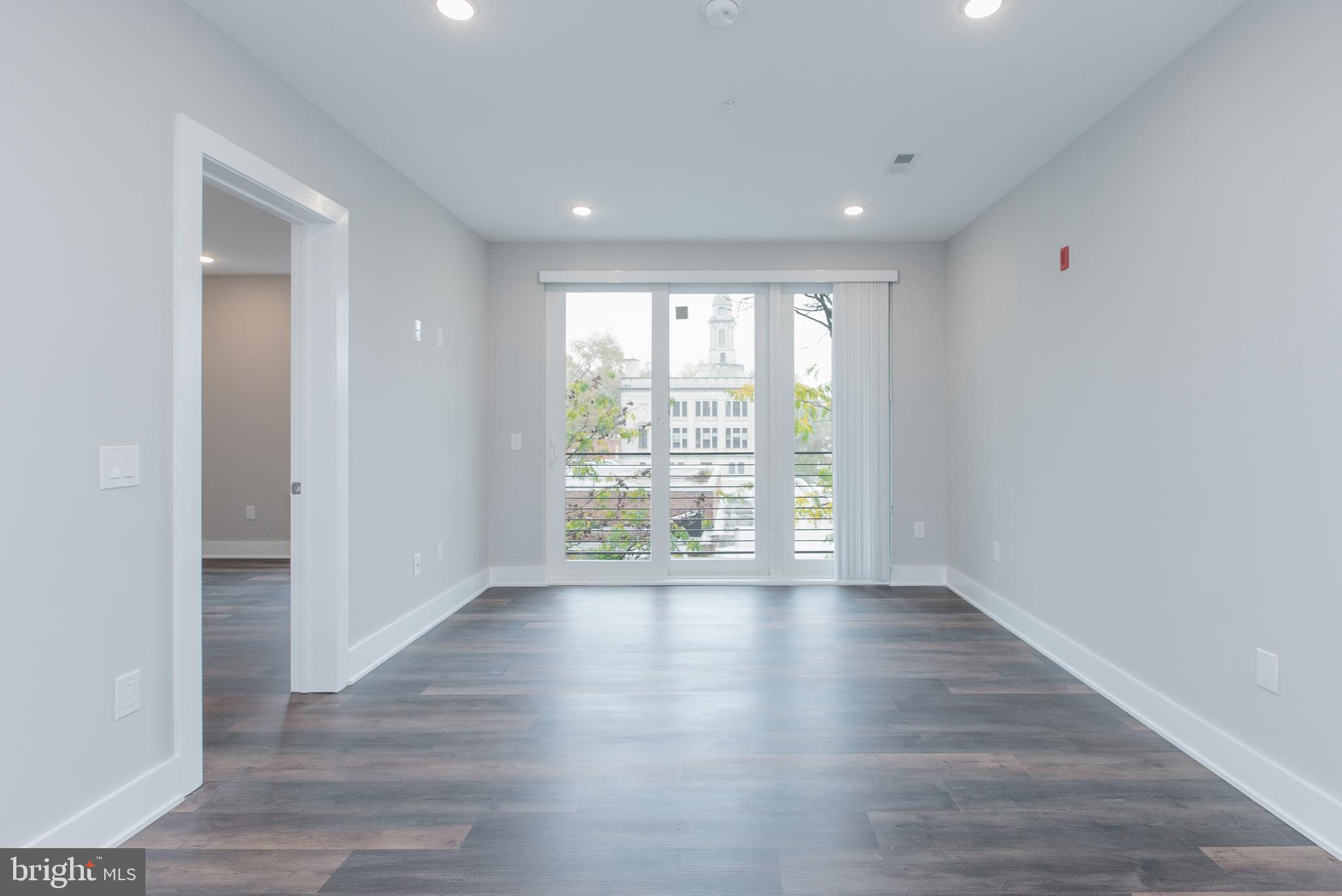45 West Haines Street, Unit 303 Philadelphia, PA 19144 - Photo 18 of 24 a view of an empty room with wooden floor and a window