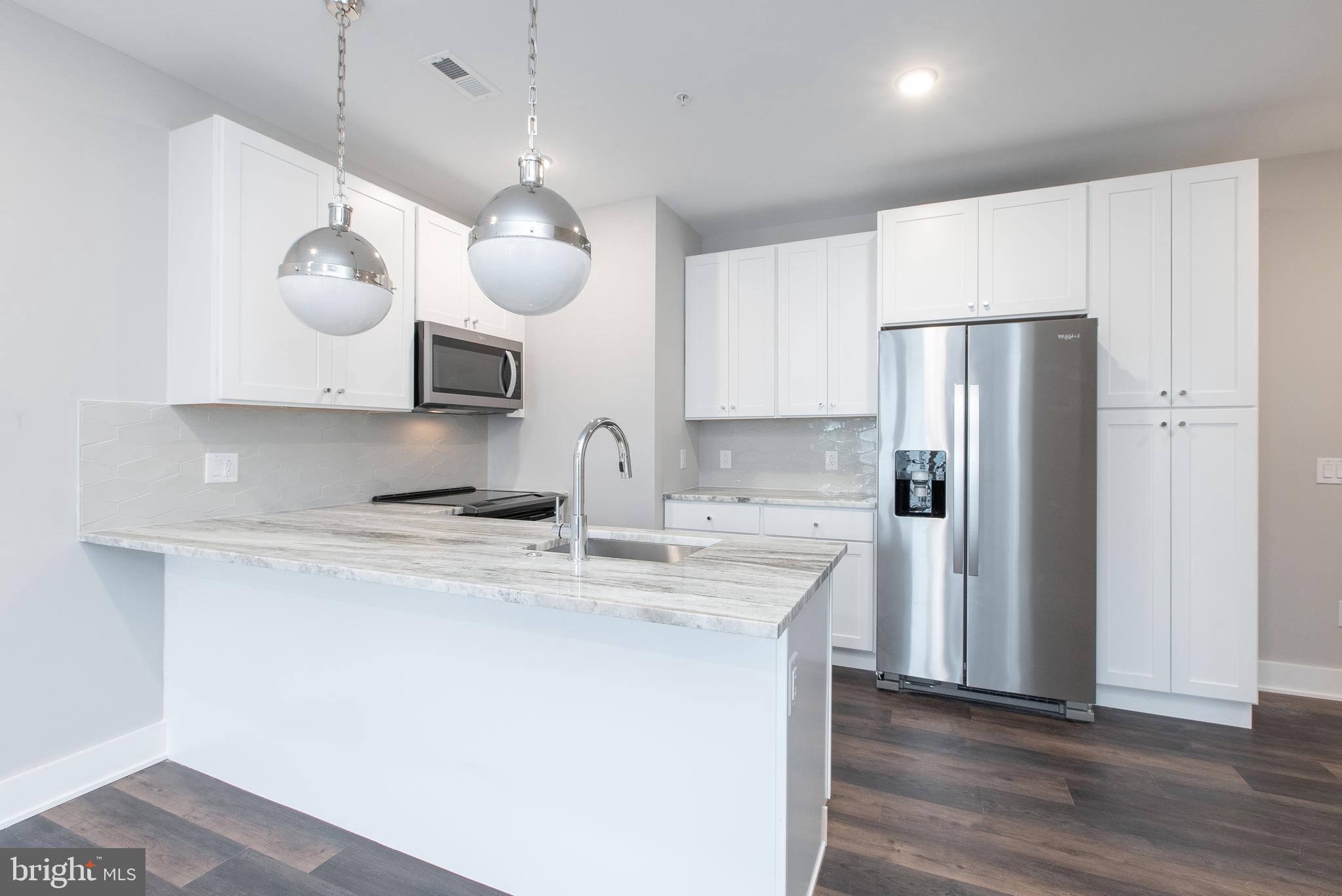 45 West Haines Street, Unit 303 Philadelphia, PA 19144 - Photo 3 of 24 a kitchen with stainless steel appliances a sink a refrigerator and a stove
