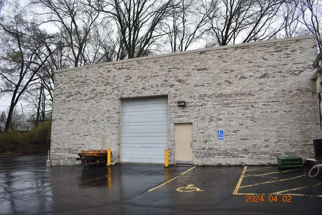 a brick building with a bench in front of it