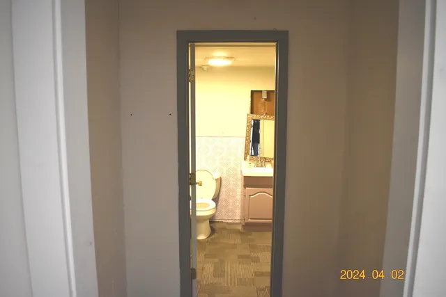 a room with walk in closet and wooden floor