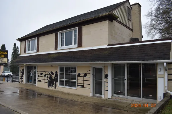 a front view of a house with glass windows and entryway
