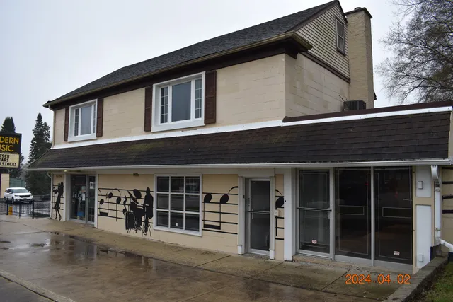 a front view of a house with glass windows and entryway