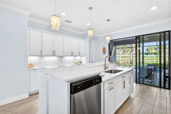 a kitchen with a sink window and cabinets