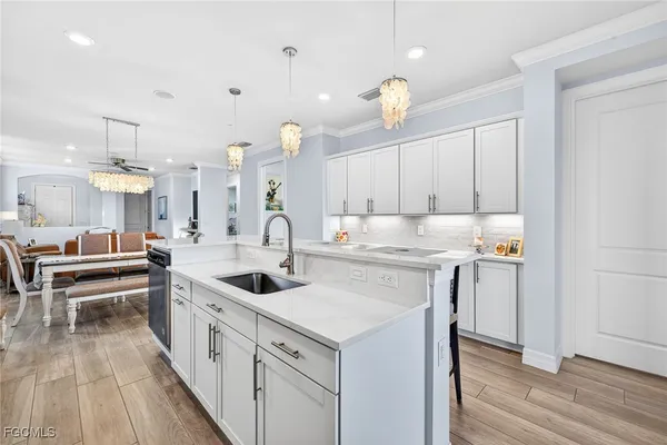 a kitchen with a sink stove and cabinets
