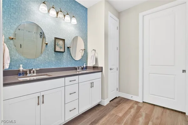 a bathroom with a double vanity sink and a mirror