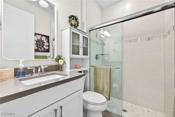 a bathroom with a sink toilet and shower
