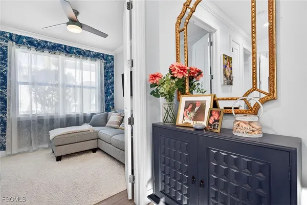 a living room with furniture and a potted plant