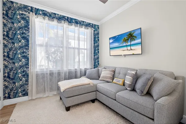 a living room with furniture and a large window